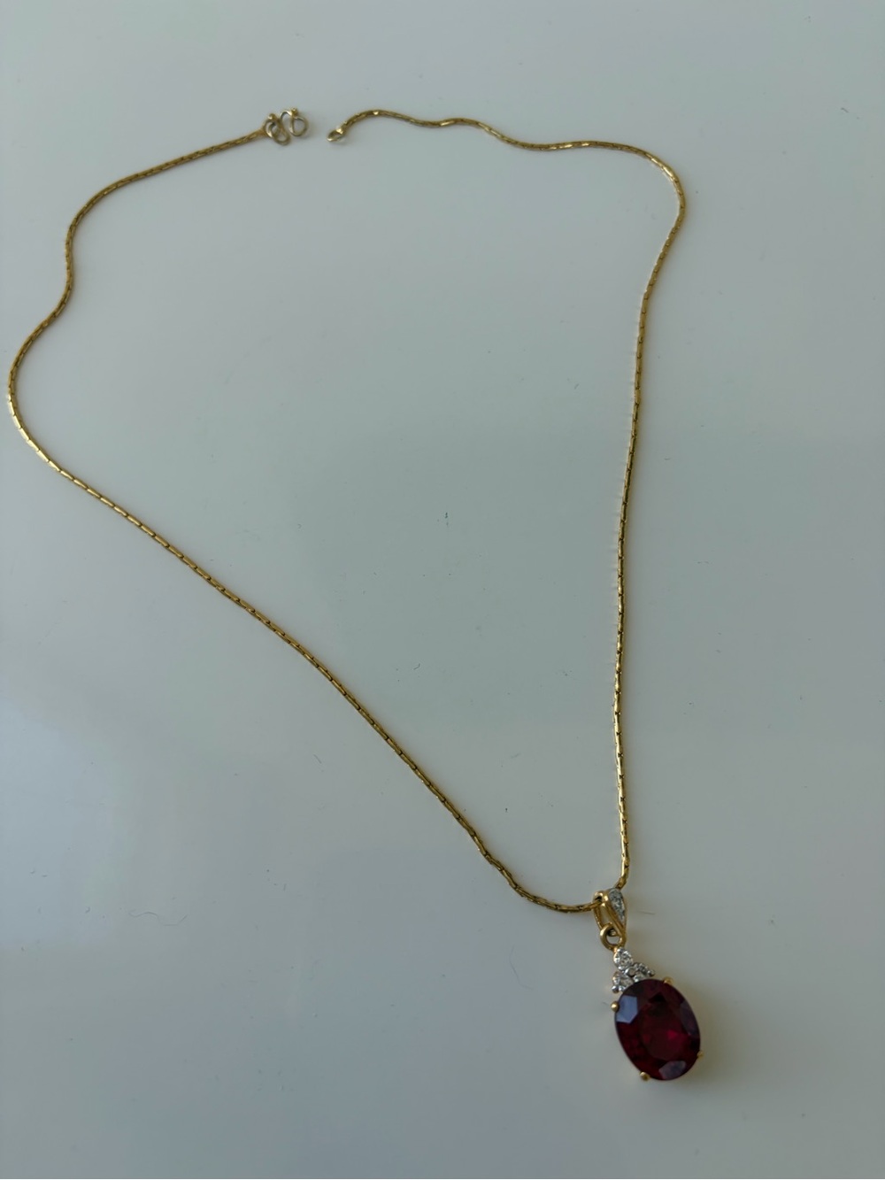 Gold chain and big red stone gold pendent